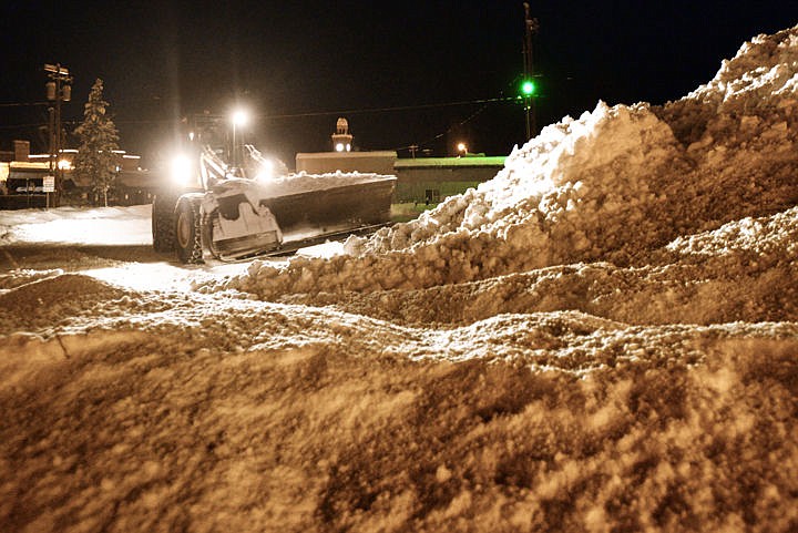 &lt;p&gt;A plow pushes snow into large piles while clearing a downtown parking lot in Whitefish on Tuesday morning. Snow-removal workers were busy all around downtown Whitefish long before sunrise Tuesday.&lt;/p&gt;