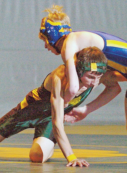 Libby's Aaron Seefeldt goes up against Whitefish's Wyatt Morris at 119 pounds. Seefeldt won by pin in 1:50.
