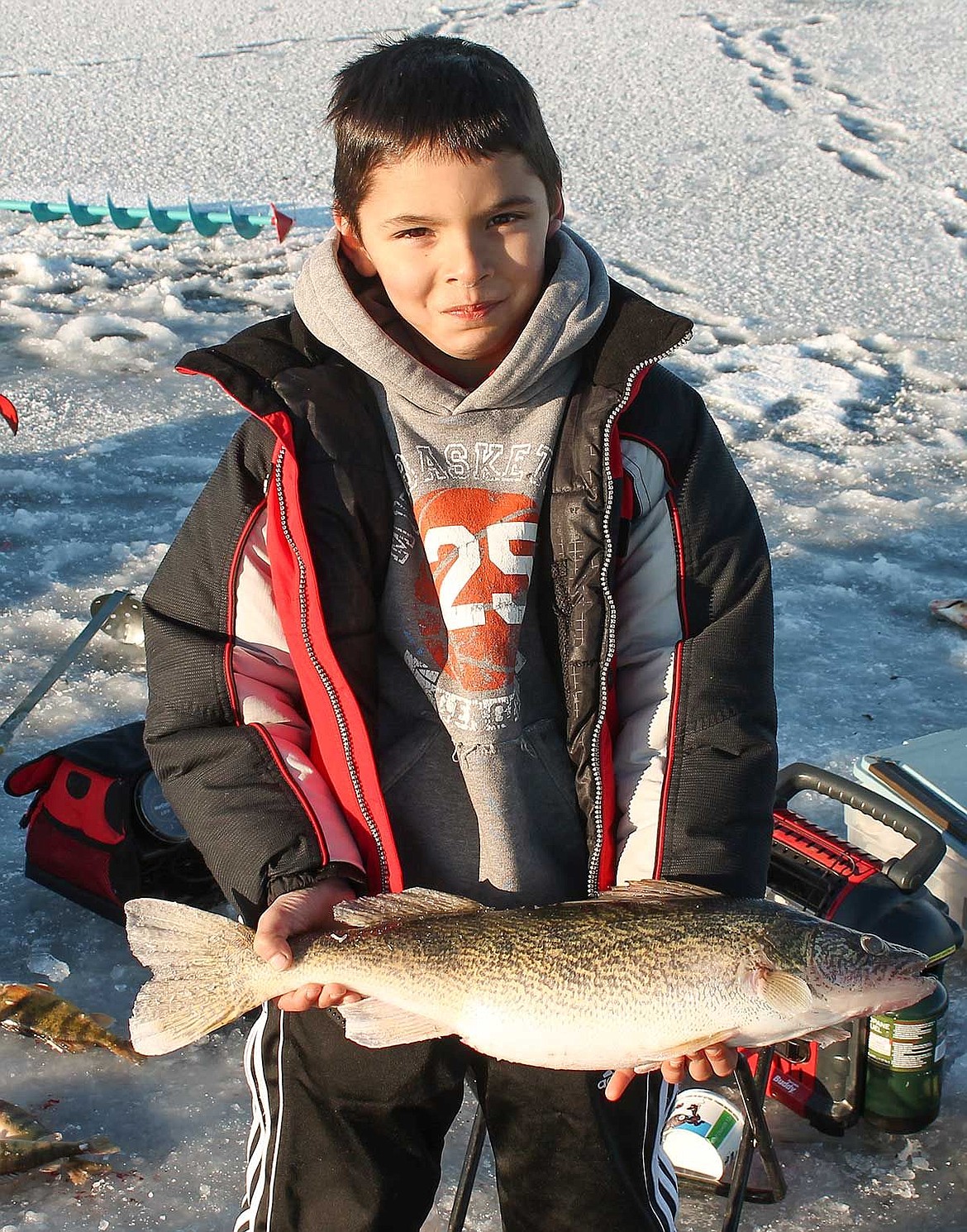 Luke Fontenelle, 8, Sammamish, shows his catch of the day, a walleye he caught while fishing with his father, Wade, on Moses Lake.