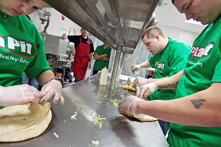 &lt;p&gt;JEROME A. POLLOS/Press Desirae Ivey, 16, left, Dylan Bertram, 18, center, and Buddy Kaylor, 18, prepare pitas for students Thursday at Project Bridge CDA as the culmination of a three-day course. Pita Pit USA provided an interactive classroom setting to explore the real world of how a local business keeps customers through its quality of service and employee commitment to a strong work ethic with purpose.&lt;/p&gt;