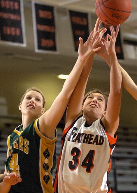 Flathead senior Ashley Brown rebounds alongside Great Falls C.M. Russell&#146;s Mary Anderson during Saturday night&#146;s game at Flathead High School. Jennifer DeMonte/Daily Inter Lake