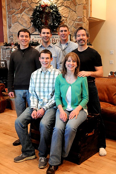 <p>Michael Reimer and his mother Julie sit surrounded by Jonathan,
left, David, Daniel and Kurt in their Whitefish home.</p>
