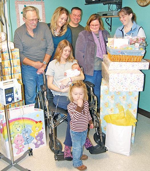 Courtesy Shayna Dobrowsky, newborn daughter Tahley and 2-year-old Zoe are surrounded by grandparents Dann and Alyce Hansen, from left, special friend Tony Barrow, St. John’s Cathy Wolf and attending physician Dr. Jana Hall.