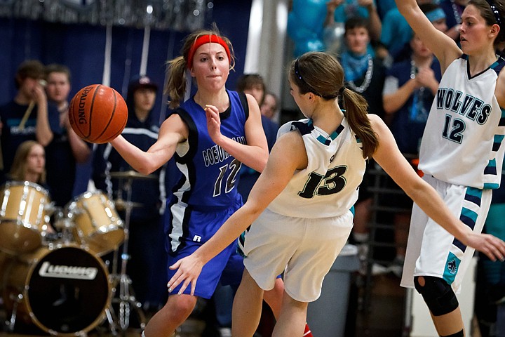 &lt;p&gt;Coeur d'Alene High's Kyeli Parker makes a pass around a falling Dailyn Ball from Lake City as Katie Rowe, right, comes in to pin Parker to the baseline Friday during the second half.&lt;/p&gt;