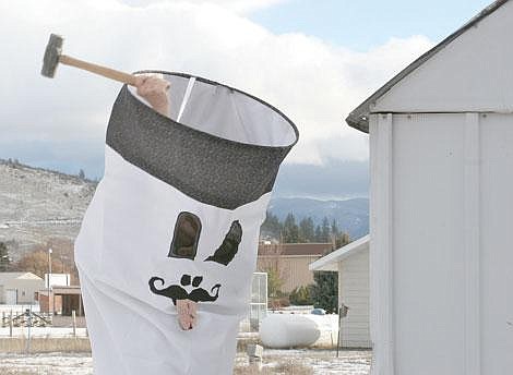 Photo by Sarah Leavenworth&lt;br&gt;Hospital volunteer Alice Balbi, dressed up in a cigarette costume she made herself, takes a big swing at the shed, formerly the designated smoking area at the hospital.