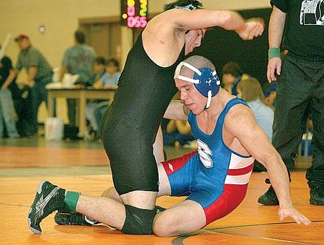 Photo by Ed Moreth&lt;br&gt;Plains-Hot Springs Savage Horseman Wes Goodwin tries to take Superior Bobcat Mike Avila to the mat during the Western Montana Duals at Ronan Saturday, but Avila escapes Goodwin's hold and goes on to pin Goodwin in 5:45. Avila, a senior, finished Saturday with a 18-4 record.