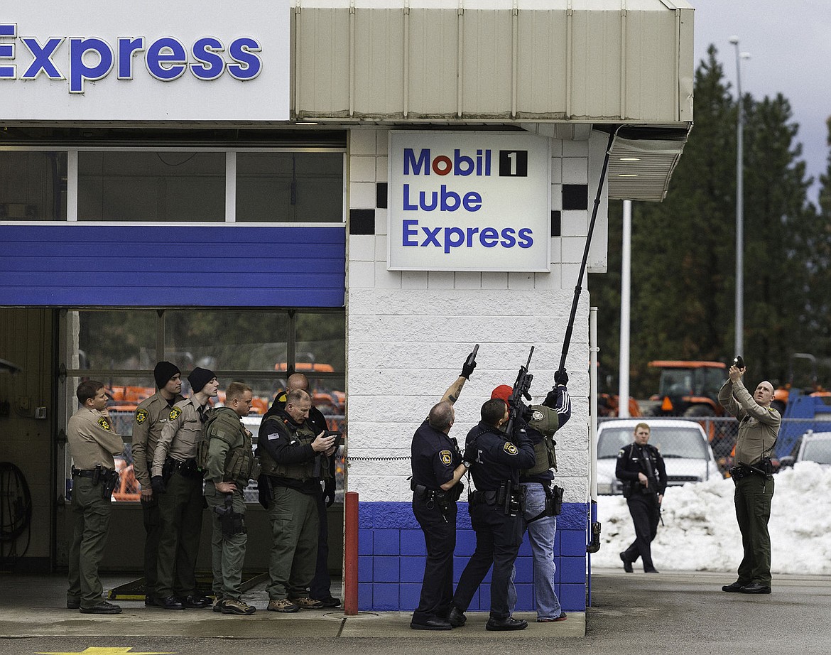 &lt;p&gt;SHAWN GUST/Press&lt;/p&gt;&lt;p&gt;Law enforcement officers from the Coeur d&#146;Alene Police Department, Kootenai County Sheriff&#146;s Office and Idaho State Patrol surround a corner of the Mobil 1 Lube Express on Appleway Avenue while using a camera to check inside a crawl space for suspect who fled police Wednesday, March 5, 2014 in Coeur d&#146;Alene.&lt;/p&gt;