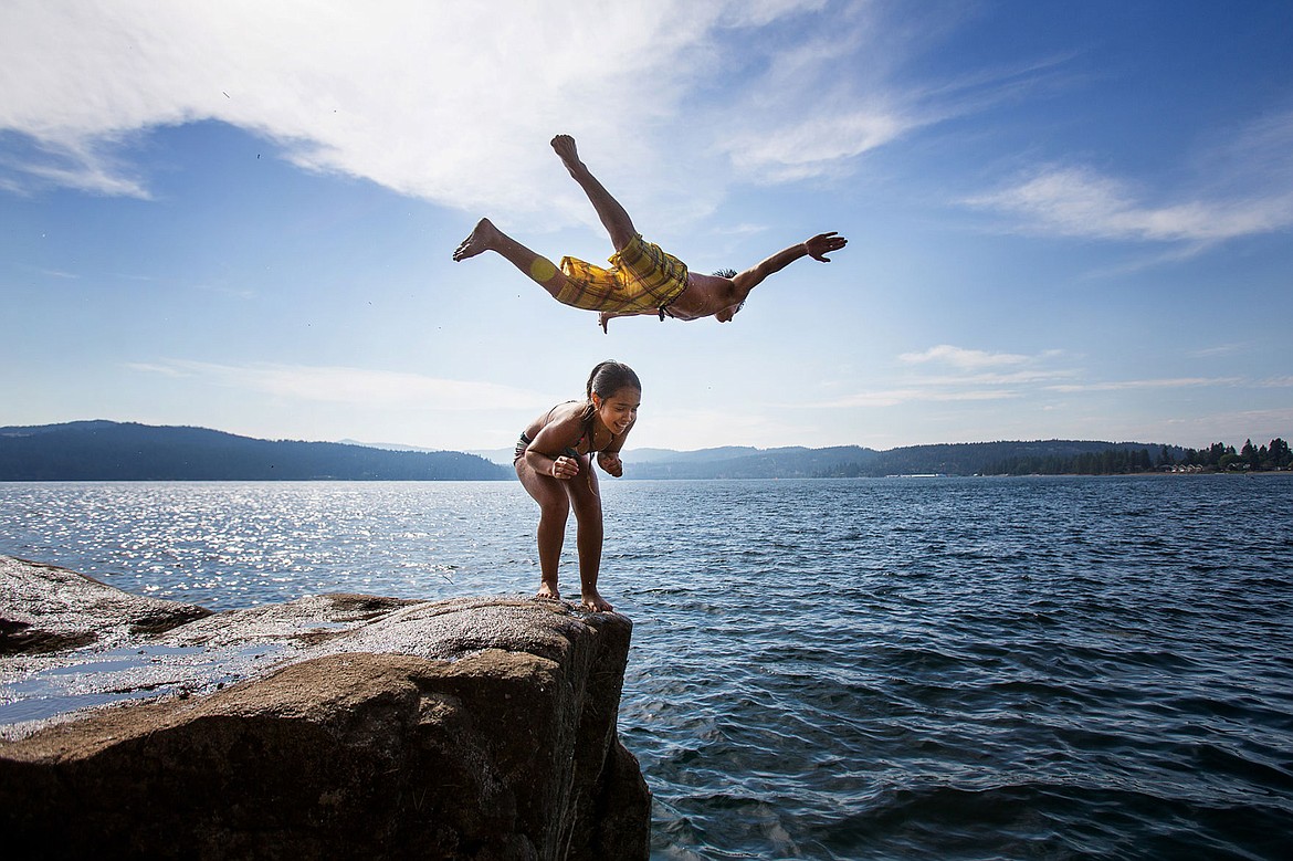 &lt;p&gt;TESS FREEMAN/Press&lt;/p&gt;&lt;p&gt;Peter Dragomir, 14, jumps off a cliff over his sister Kristina Dragomir, 13, on Tubbs Hill Tuesday, August 12, 2014.&lt;/p&gt;