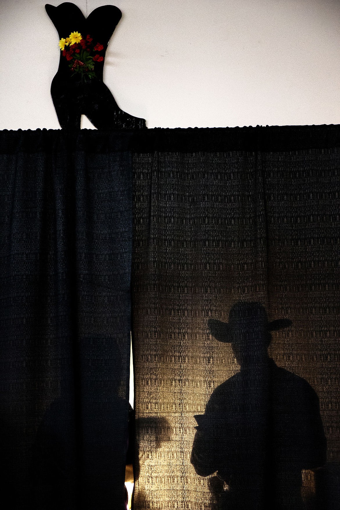 &lt;p&gt;GABE GREEN/Press&lt;/p&gt;&lt;p&gt;A cowboy stands behind a black curtain Friday, April 4, 2014 during the Cowboy Ball at the North Idaho fairgrounds.&lt;/p&gt;