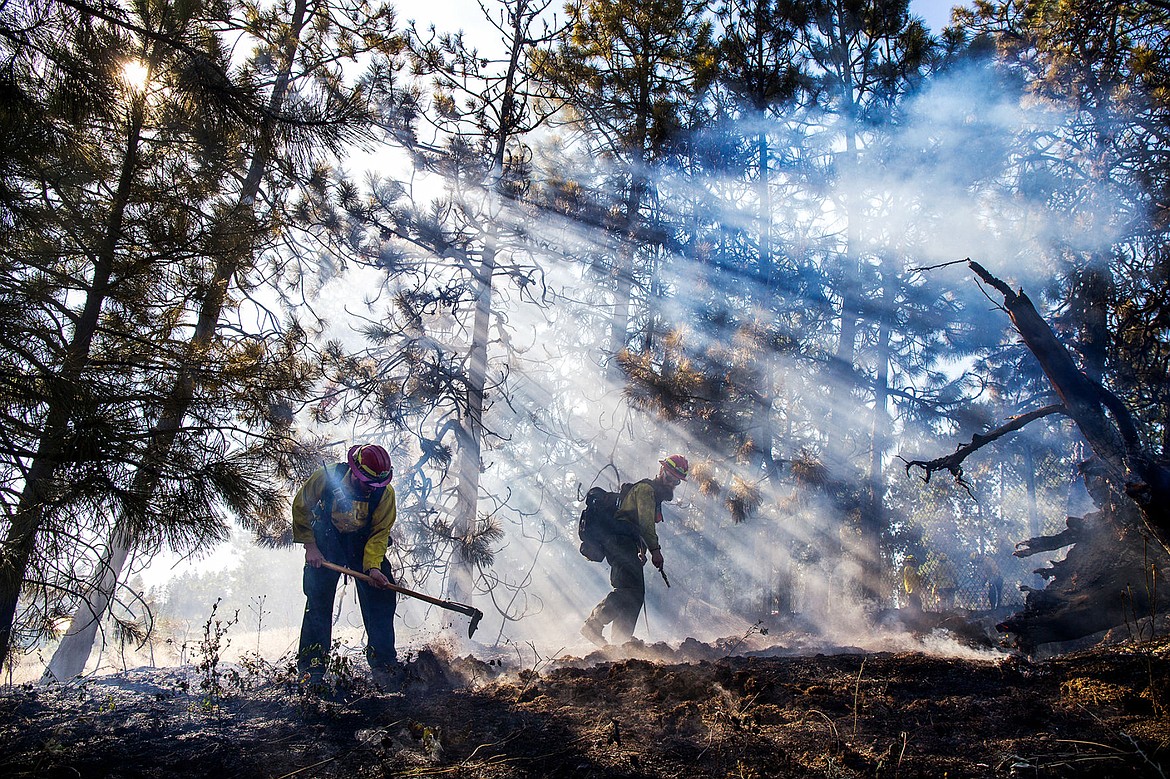 &lt;p&gt;TESS FREEMAN/Press&lt;/p&gt;&lt;p&gt;Sheldon Dissinger&#160;and Travis Hixson&#160;of the Idaho Department of Lands&#160;extinguish a grass fire that started next to the Centennial Trail alongside I-90 on Tuesday, July, 29, 2014.&lt;/p&gt;