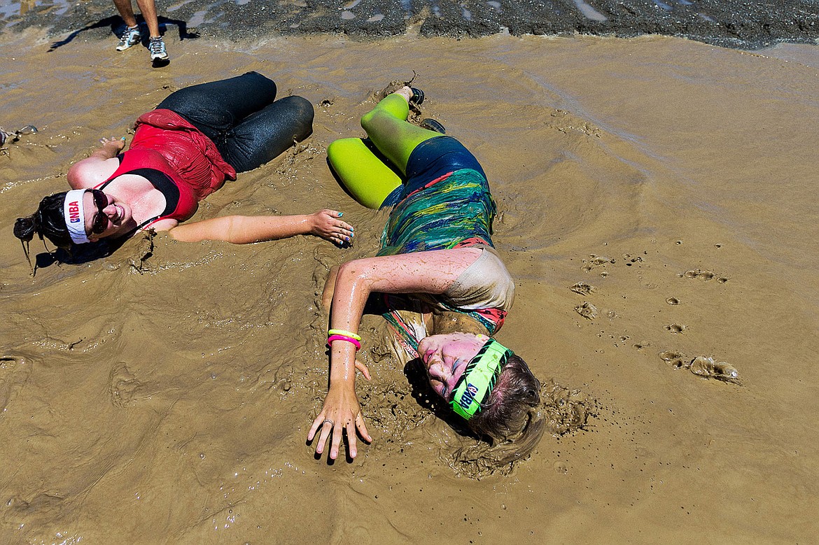 &lt;p&gt;SHAWN GUST/Press&lt;/p&gt;&lt;p&gt;Coeur d&#146;Alene residents Andrea Shanklin, right, and Stephanie Orlando squirm in a muddy pool during the Pig Pen Mud Run Saturday, June 21, 2014 at the Kootenai County Fairgrounds. The event, in its first year, is hosted by the Kootenai County Sheriff&#146;s Office to raise funds for Idaho Special Olympics. Area businesses as well as some 50 participants helped raise more than $700 that will benefit 200 Special Olympics athletes in Kootenai County.&lt;/p&gt;