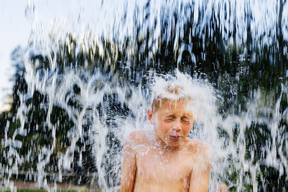 &lt;p&gt;SHAWN GUST/Press&lt;/p&gt;&lt;p&gt;Christian Schmidt, 8, is drenched by a flood of water as it falls from a splash pad feature above his head while seeking reprieve from temperatures in the 90s Monday, July 14, 2014 at McEuen Park in Coeur d&#146;Alene.&lt;/p&gt;