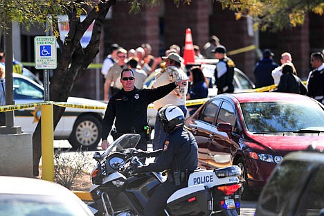 &lt;p&gt;Emergency workers gather at the scene of a shooting involving Rep. Gabrielle Giffords, D-Ariz., Saturday at a Safeway grocery store in Tucson, Ariz.&lt;/p&gt;
