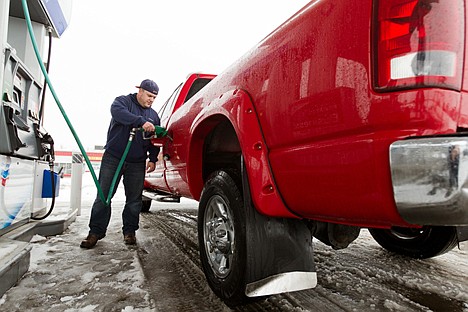 &lt;p&gt;Jayson Frank fills up his pickup truck Tuesday at a gas station in Hayden. Fuel prices have continued to fall into 2013.&lt;/p&gt;