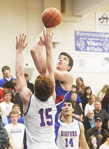 <p>Columbia Falls senior forward Grant Stenger floats a shot over Bigforks Josh Sandry (15) during the third quarter of Thursdays nonconference basketball game at Bigfork High School. (Aaric Bryan/Daily Inter Lake)</p>
