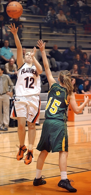 Flathead junior Christyne Hanson (12) puts up a shot over Whitefish junior Karissa DeMarco (15) during Friday&#146;s nonconference basketball game at Flathead.