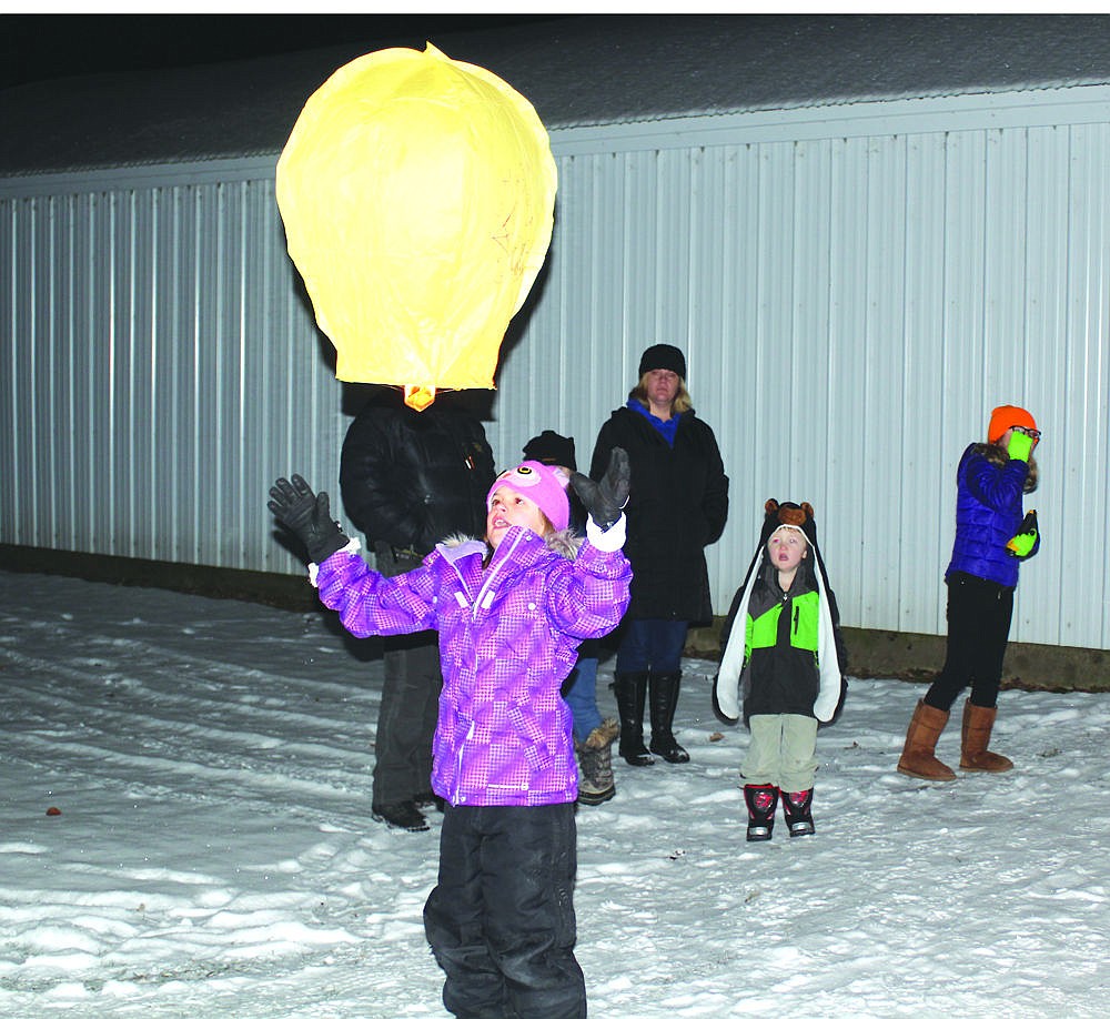 &lt;p&gt;RuBea Privett watches as a lantern takes flight on New Year's Eve during the Cancer Network of Sanders County's annual launch event at the fairgrounds.&lt;/p&gt;