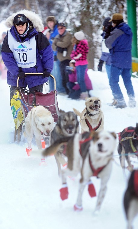 A crowd of onlookers cheers as Dawn Breedlove of Bryant, Wisc., starts her race in the 10-12 dog class on day one of the Flathead Sled Dog Days Saturday in Olney. Breedloves time for running the 36 mile course was 2:53:22. She was in first place at press time.