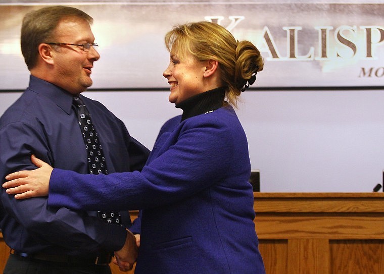 Kalispell Mayor Tammi Fisher shakes hands with new council member Jeff Zauner after both took their oaths of office during the Kalispell City Council meeting on Monday night.