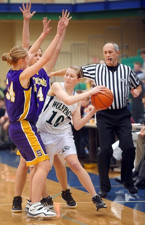 Glacier junior Rachel Cutler (10) makes a pass under pressure from two Missoula Sentinel players on Thursday.