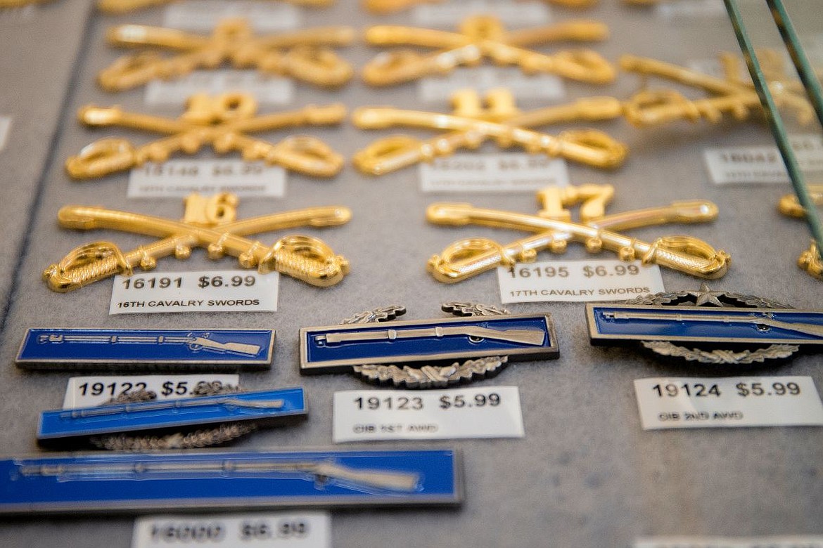 &lt;p&gt;Blue United States Army combat infantry badges are displayed beneath gold cavalry sword badges in the military pin cabinet at the American Legion Post 143 in Post Falls.&lt;/p&gt;