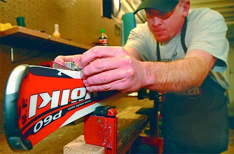 Steve Stevens carefully files the edge of a ski in the basement shop of Ski Mountain Sports on Thursday in Whitefish. Stevens has been an employee for five years and has skied for 20. Jennifer DeMonte/Daily Inter Lake