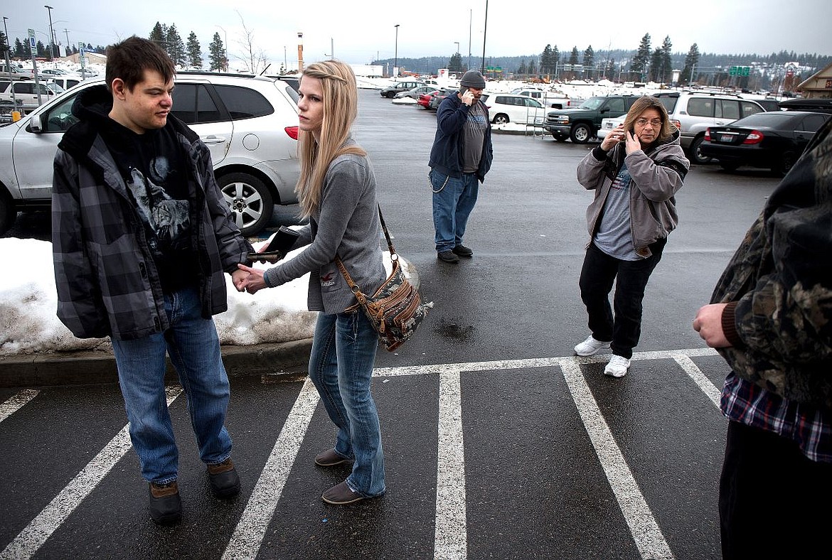 &lt;p&gt;&#160;In the Coeur d'Alene WinCo Foods parking lot before a grocery shopping trip on Thursday, caregiver Laurie West, right, recieves a call letting her know her son, who has mental disabilities, had a bad fall at his home as Robert Moore, center, makes arrangements so he can leave the group and drive West to tend to her son. Caregiver Zina Mack, second from left, holds Blaine Rutherford's hand and is now responsible for looking after Rutherford and Cody (last name) as the men shop for food using food stamps. Situations like this, where staff members are forced to spread themselves thin, are common, and if the financial cuts go through, taking the men on public outings will be next to impossible due to the lack of staff, Mack says.&lt;/p&gt;