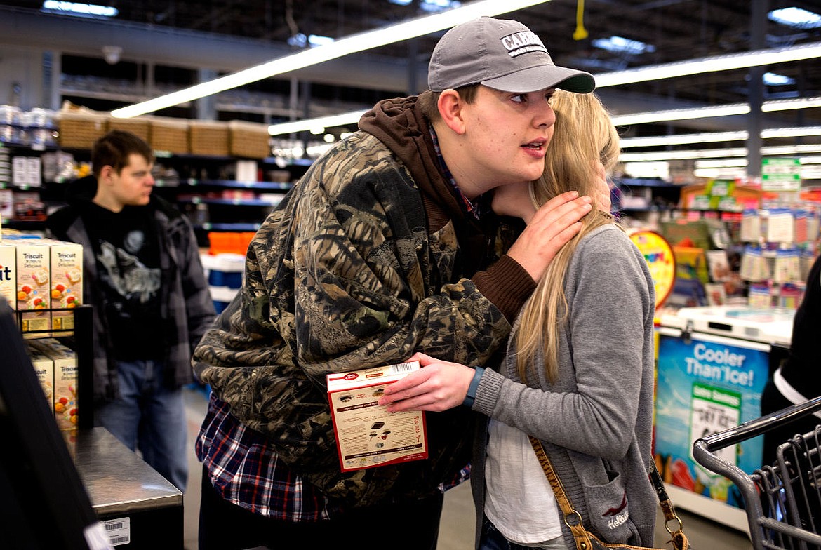 &lt;p&gt;Cody gives Zina a hug as they use the self-checkout machine while Blaine waits behind them on Thursday in WinCo Foods in Coeur d'Alene. As a person who requires &quot;high support,&quot; Cody canot live on his own&#151;he needs help cooking food, doing household chores and other everyday activities.&lt;/p&gt;