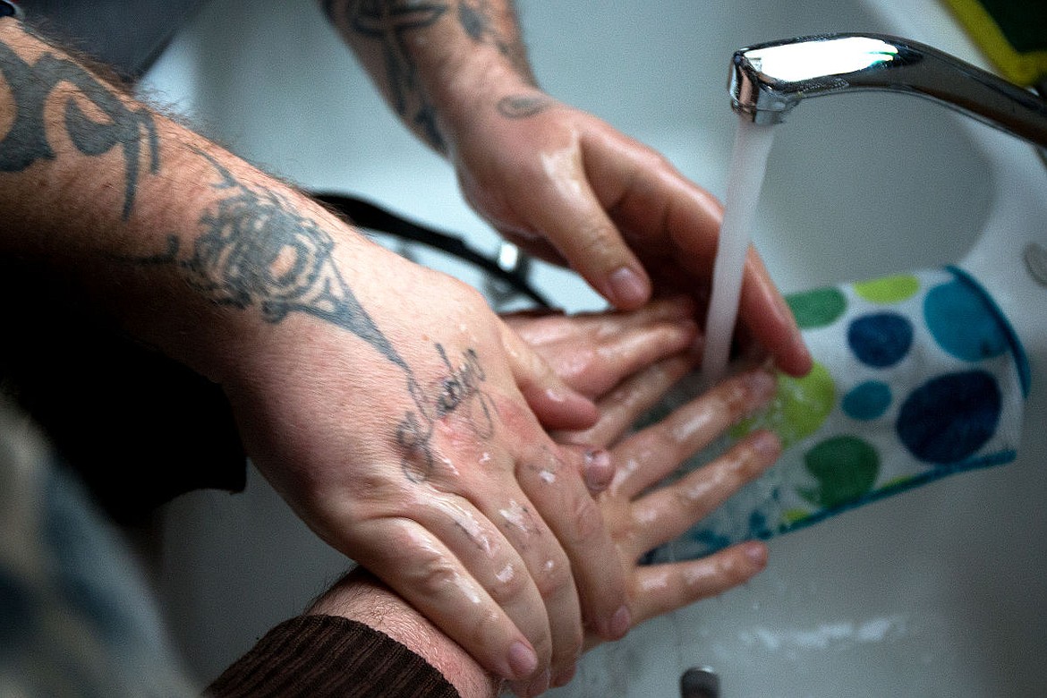 &lt;p&gt;Milestones caregiver Robert Moore helps Cody wash his hands after eating lunch on Thursday at Cody's home in Coeur d'Alene. Moore, who is the house manager at Cody's home, has worked with Cody for more than seven years.&lt;/p&gt;