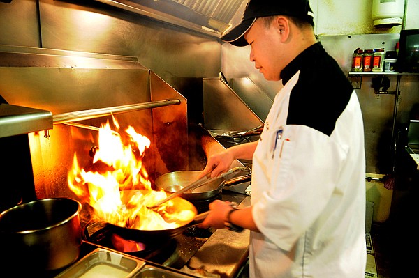 &lt;p&gt;Tien Pham Windauer cooks up a dish of Kung pao chicken on
Tuesday at Tien's Place Oriental Dining in Columbia Falls.&lt;/p&gt;