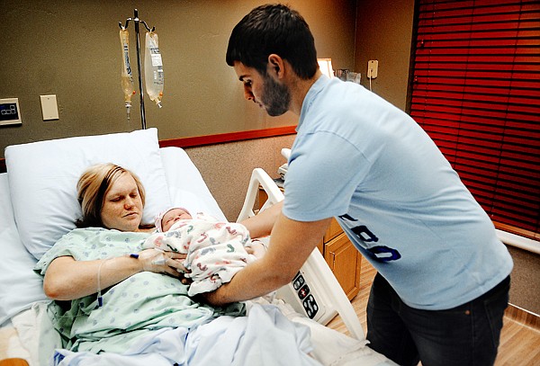 &lt;p&gt;Austin Miller hands his hours old daughter, Raylee Miller, to
mother Karli Aurich on Tuesday afternoon at Kalispell Regional
Medical Center. Raylee is the first baby born in Kalispell this
year. She was born at 9:34 Tuesday morning.&lt;/p&gt;