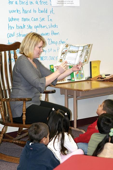 Chrystal Doucette/Columbia Basin HeraldMountain View Elementary School teacher Sheena Miller reads a book to children as Quincy board members tour kindergarten classrooms Tuesday.