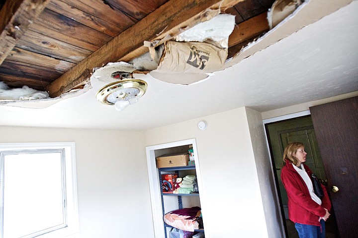 &lt;p&gt;JEROME A. POLLOS/Press Sally Richards, with ElderHelp of North Idaho, stands in the bedroom of Larene &quot;Billie&quot; Stone's home where a leaky roof caused a portion of her ceiling to collapse. ElderHelp of North Idaho coordinated efforts with the Precision Roofing, Creekside Construction and the City of Post Falls fix Stone's roof and ceiling.&lt;/p&gt;