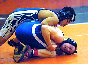 Thompson Falls junior Rod Carew battles Hunter Fishel of Columbia Falls in the 112 pound weight class in Ronan over the weekend.
