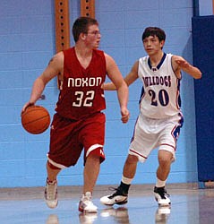 Junior guard Jordan Eichart shields the ball from a Mission defender during a 33-48 loss on the road.