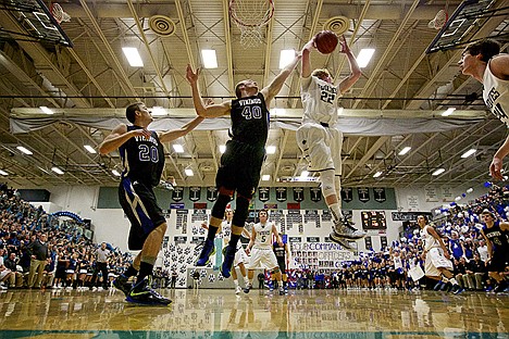 &lt;p&gt;Lake City High's Kyle Guice pulls down a rebound in front of Kelton Hunter and Justin Carpenter, left, during the first half of the T-Wolves 50-47 win over the Vikings.&lt;/p&gt;