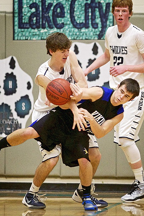 &lt;p&gt;Coeur d'Alene High's Jared Moore fights for position with Riley Moreen from Lake City as they both go after a loose ball.&lt;/p&gt;