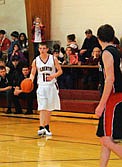 Todd Myrstol dribbles the ball down court and looks for an open teammate.