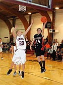 Jack Lehl blocks a Hot Springs shooter's shot from going into the basket.