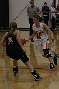 Junior guard Kelsey Beagley changes direction on her dribble while a Lion defender does her best to keep up.