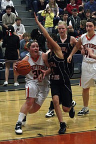 Nikki Kunzer drives hard to the basket as she gets tangled up with a Eureka defender on Saturday.