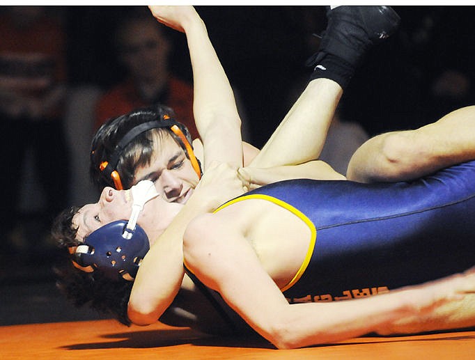 &lt;p&gt;Flathead's Payton Hume puts Missoula Big Sky's Wyatt Shinn in a cradle hold before pinning him in the first period during their 138-pount match at the dual at Flathead. (Aaric Bryan/Daily Inter Lake)&lt;/p&gt;