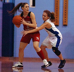 Junior point guard Kim Marich protects the ball from a Mission defender. Marich would lead the Lady Devils with 30 points in the 51-32 win.