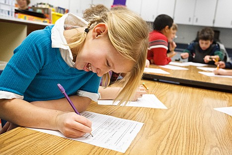 &lt;p&gt;Taylor Johnson, a third-grader at Skyway Elementary School, fills out a worksheet Thursday during a school-wide writing festival where students learned writing skills from area authors.&lt;/p&gt;