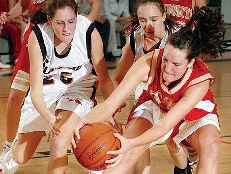 Flathead&#146;s Chelsea Vaudt (left) and teammate Christina Zorn battle for a loose ball with Missoula Hellgate&#146;s Kristen Vaculik during first-half play Thursday night in Kalispell. Flathead rolled to a 60-32 victory. Chris Jordan/Daily Inter Lake