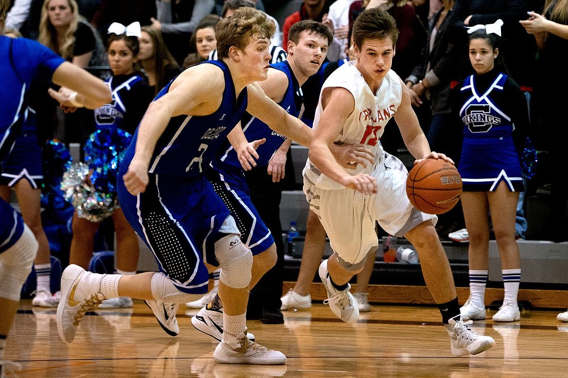 &lt;p&gt;JAKE PARRISH/Press Post Falls' David Bourgard drives to the key past Coeur d'Alene's Joey Naccarato, left, and Austin Lee on Tuesday at Post Falls High School.&lt;/p&gt;