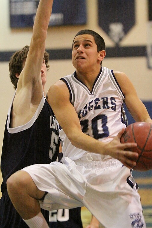 Bonners Ferry junior guard No. 20 Andre Zarate completes a fast break during non-league basketball action Monday night against Lake City. The Badgers lost the game 37-47.  &#8211;Photo courtesy of LOREN ORR