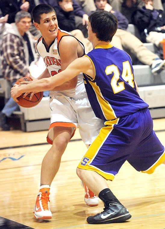 Flathead junior Mike VanArendonk (33) tries to get around Missoula Sentinels Trevor Olson during the first half of Tuesdays Western AA game in Kalispell.