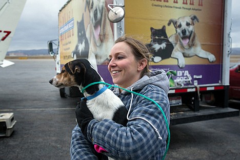 &lt;p&gt;Humane Society volunteer Christina Hull holds one of 32 dogs transported from a shelter in Sacramento, California Saturday at the Coeur d&#146;Alene Airport. The Dogs will be given a new residence at the Kootenai Humane Society which is a no-kill shelter.&lt;/p&gt;