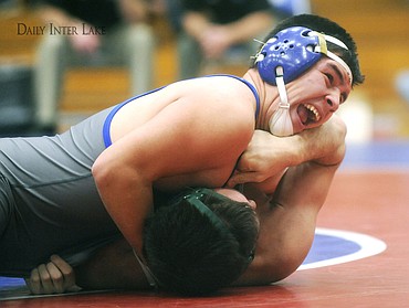 <p>Columbia Falls' Miguel Hagarte pins Whitefish's Matt Carr at the 44-second mark of the first period of the 183-pound match at Columbia Falls on Tuesday. The Mat Cats won the dual 58-12. (Aaric Bryan/Daily Inter Lake)</p>